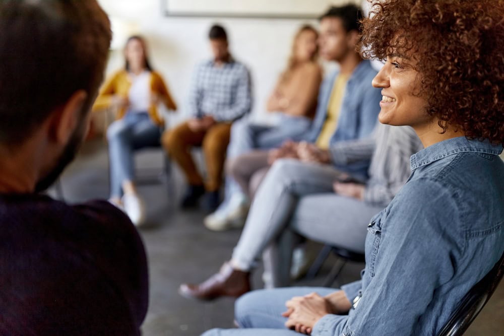 Adults seated in a circle during a group conversation