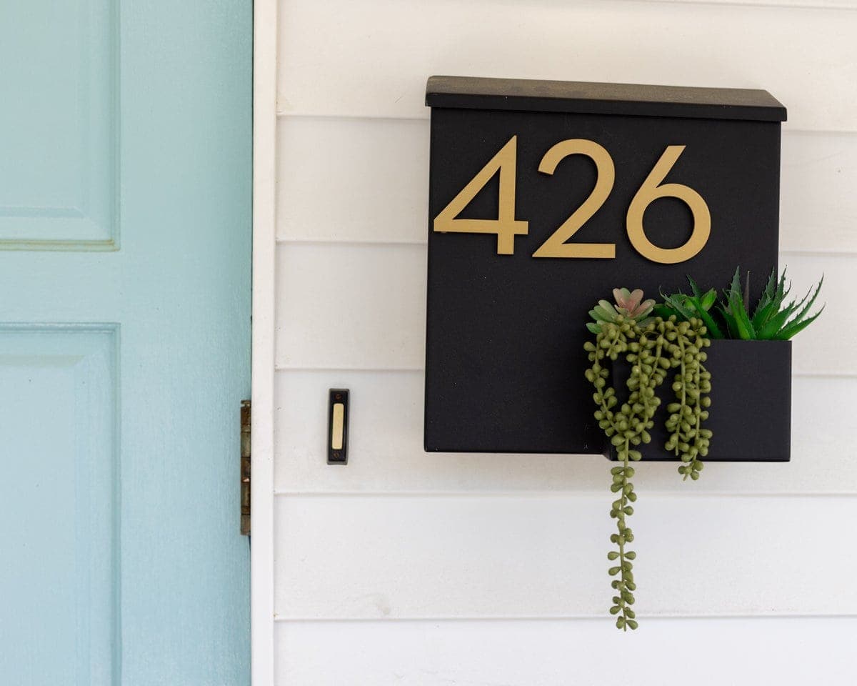 Black mailbox numbered 426 beside the teal Lexington office door