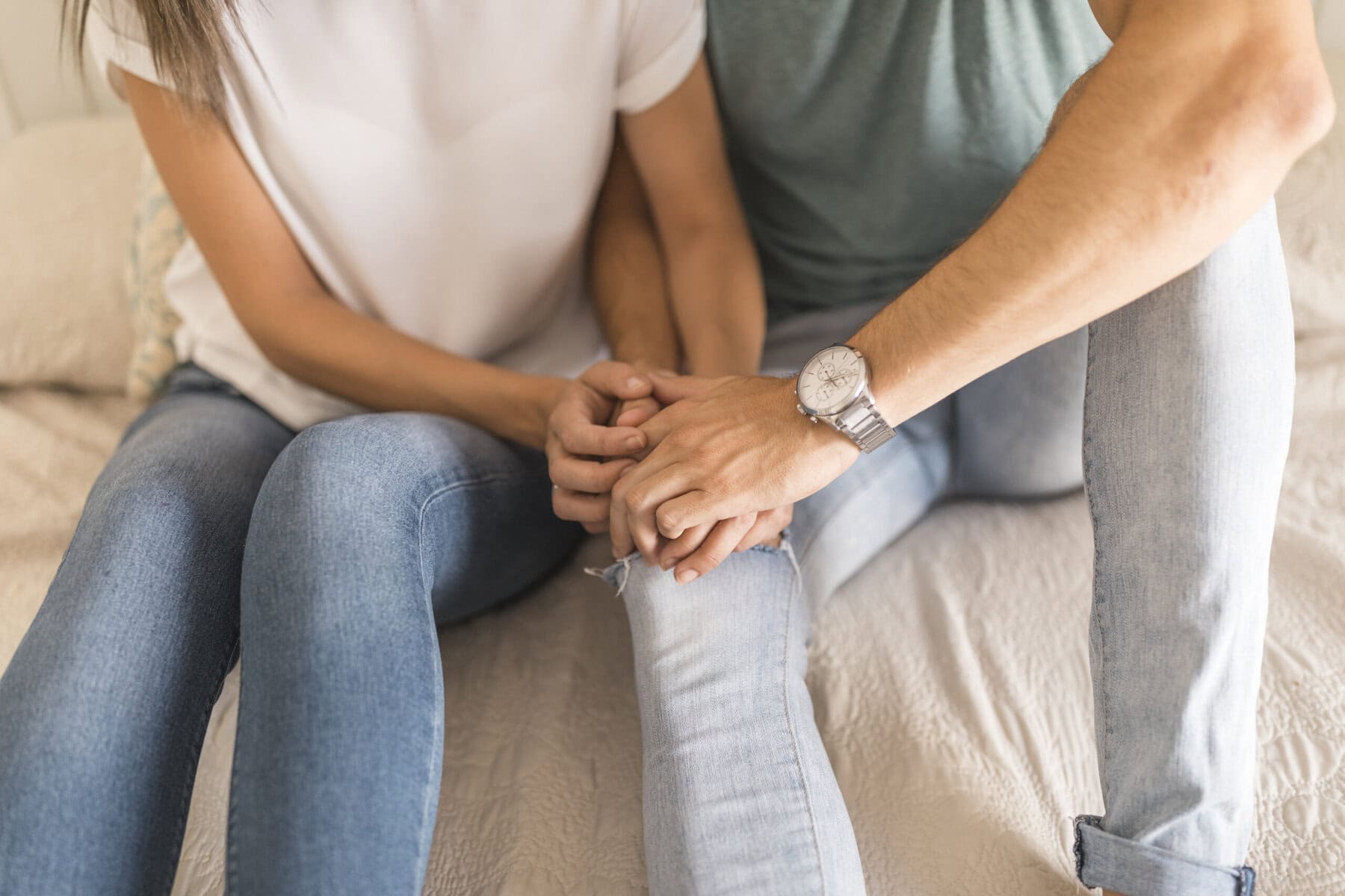 Couple sitting together and holding hands