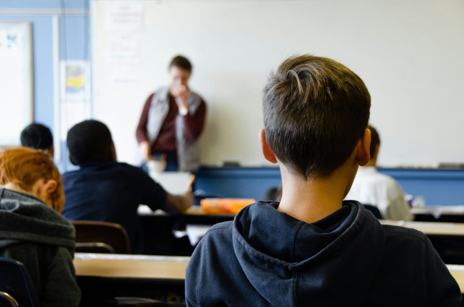 Student seated at a desk in a classroom