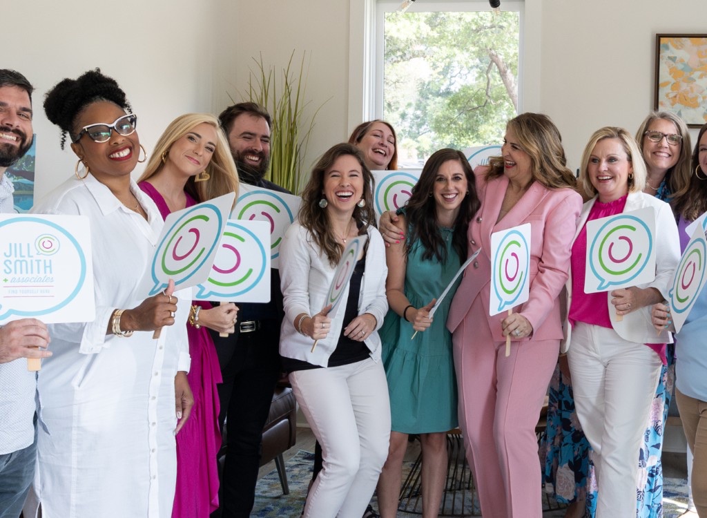 Jill Smith & Associates clinicians holding speech-bubble signs