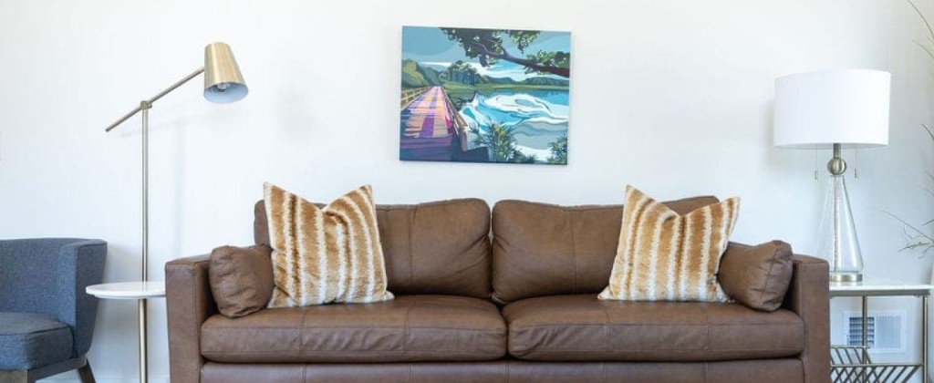 Warm counseling lounge with leather sofa and landscape art