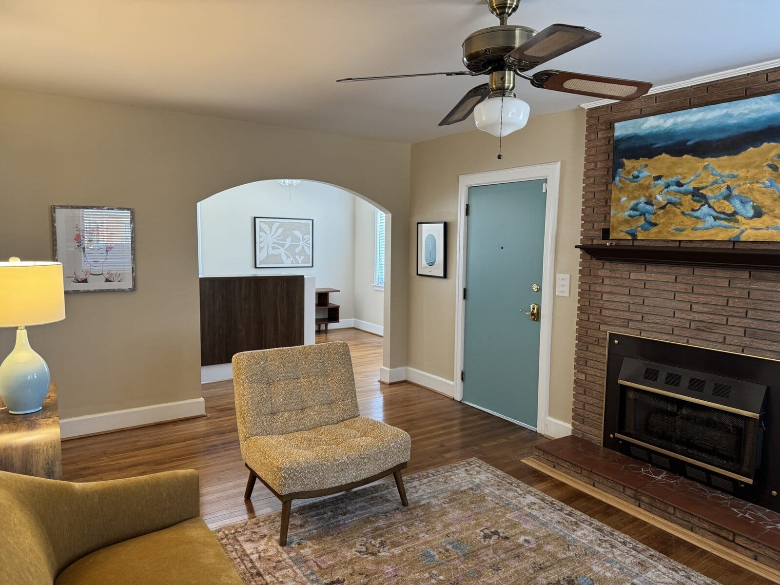 Brick fireplace and teal door in the Blythewood office waiting room