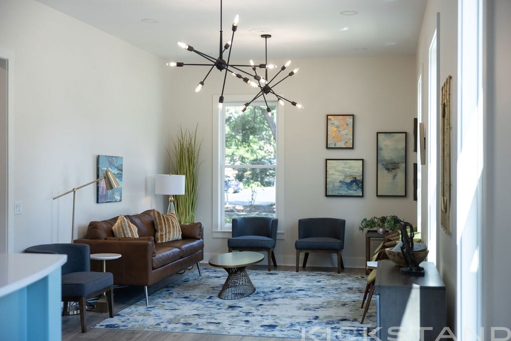 Columbia office lobby with a brown leather sofa, blue chairs, and a window looking onto trees