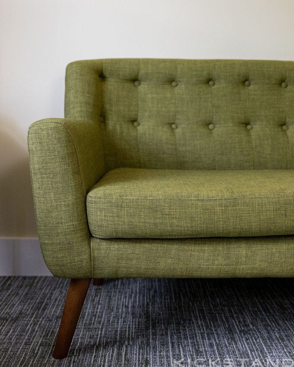 Olive green tufted sofa in a Columbia counseling room