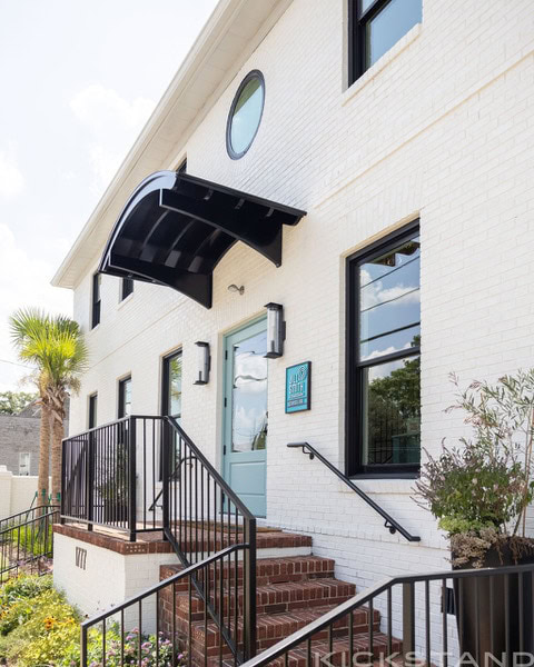 Brick steps leading to the teal door of the Downtown Columbia office